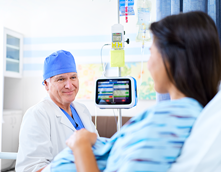 Doctor with a pregnant patient. Plum Duo and CADD solis pump being used in the background.