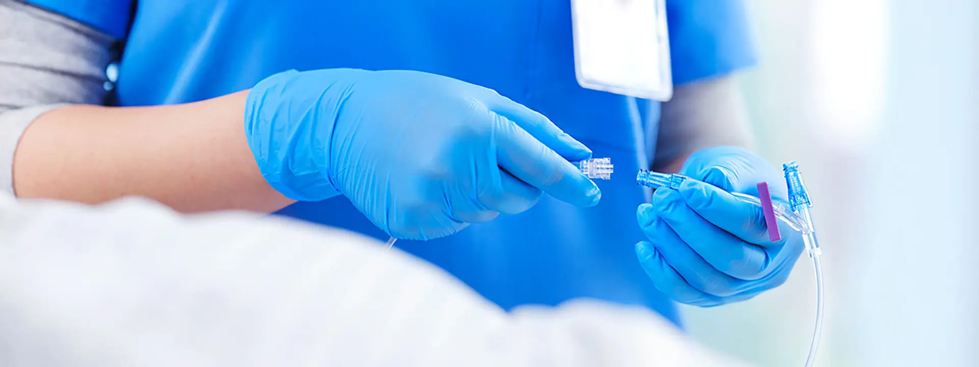 Closeup of nurse using IV connectors.