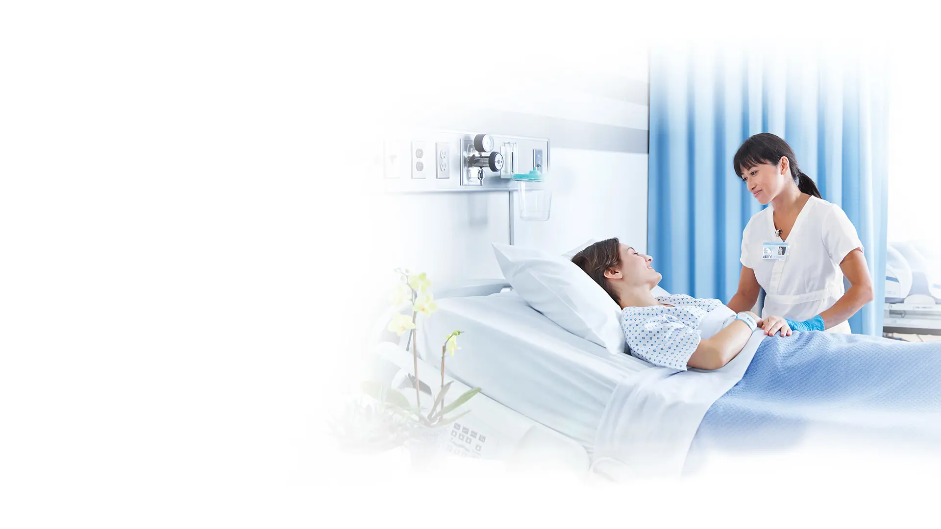 nurse with patient in hospital room