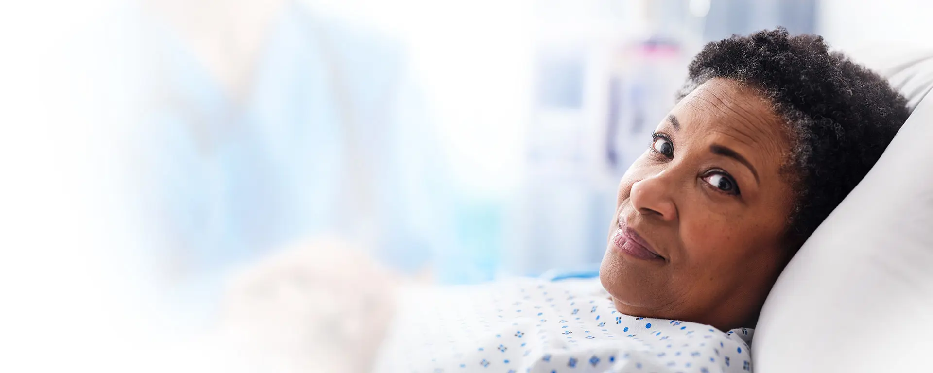 patient in hospital bed smiling