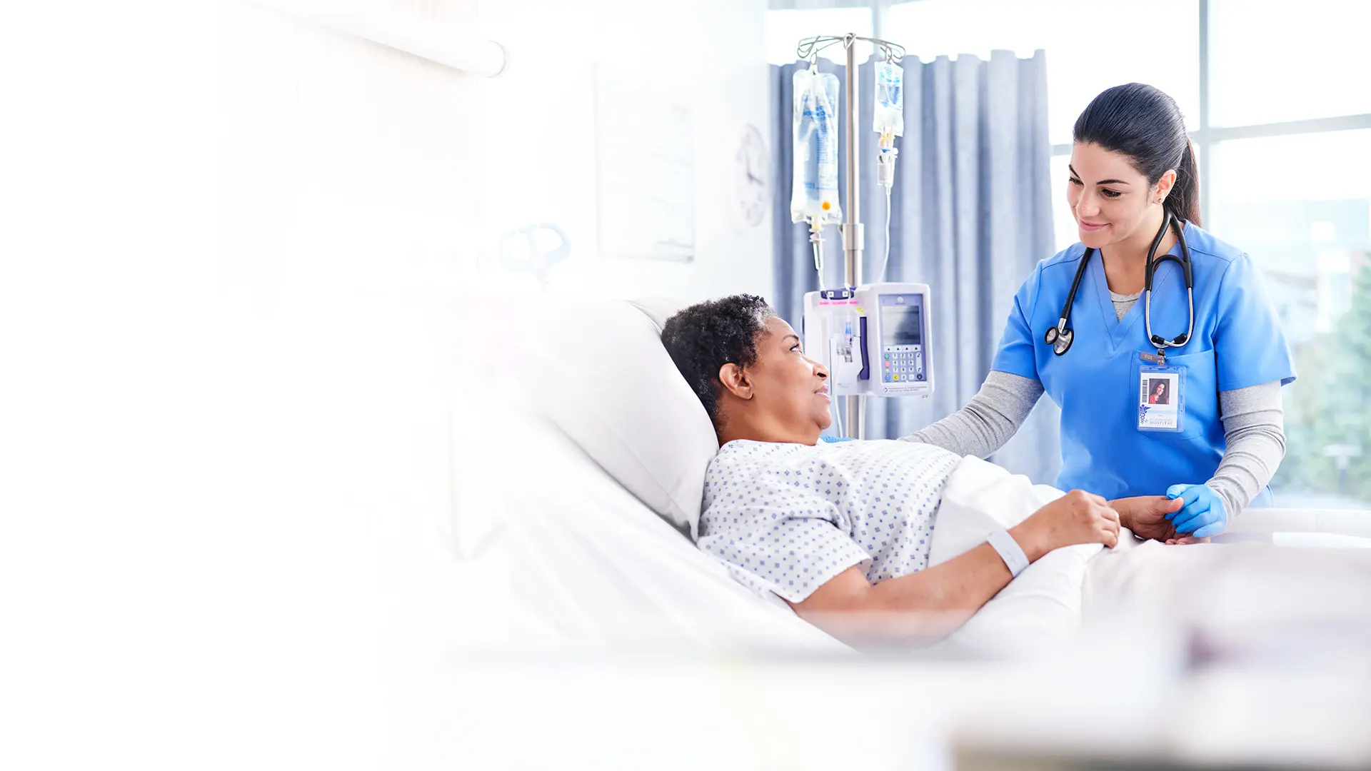 nurse with patient in hospital room